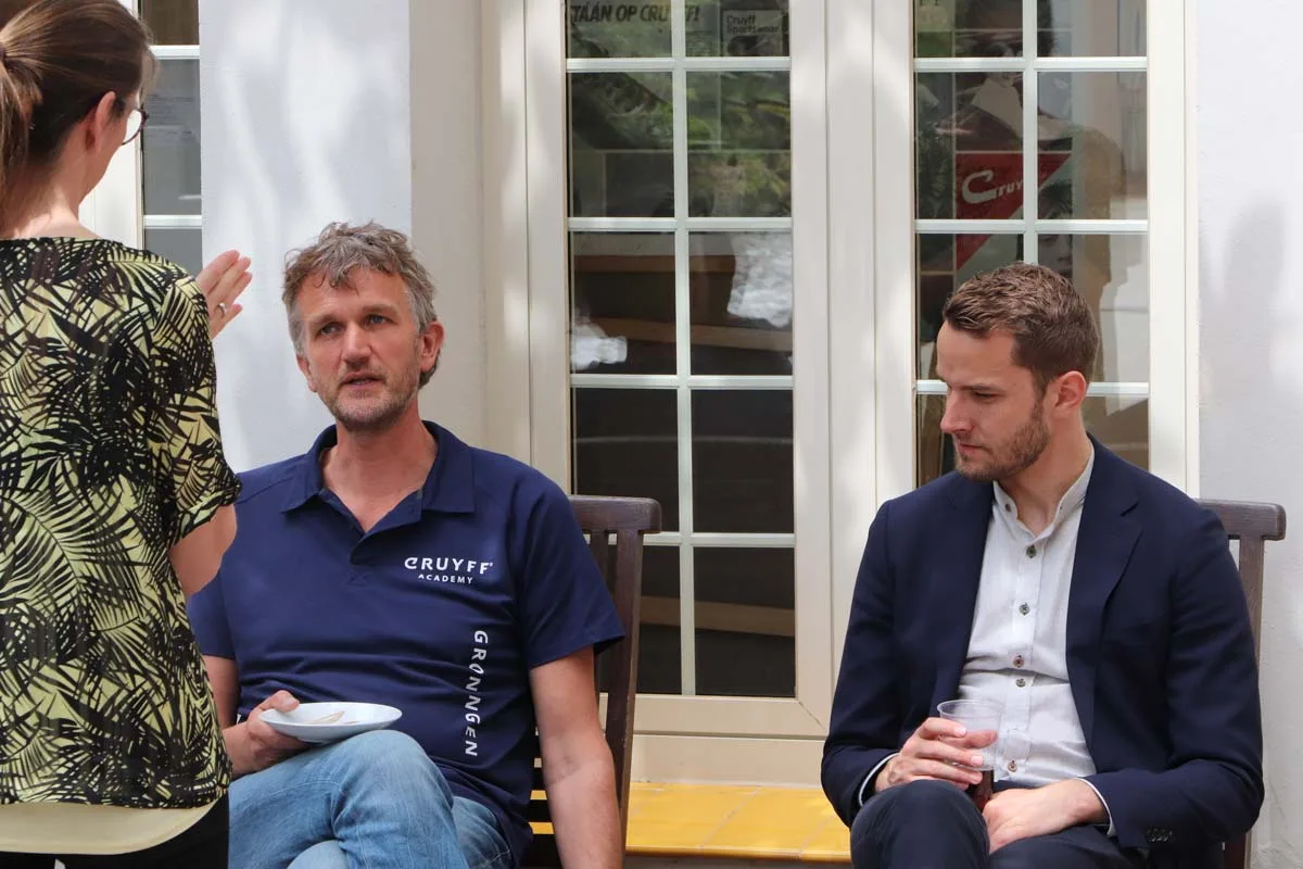 Johan Cruyff Academy teachers taking a break outside Johan Cruyff Institute's HQ.